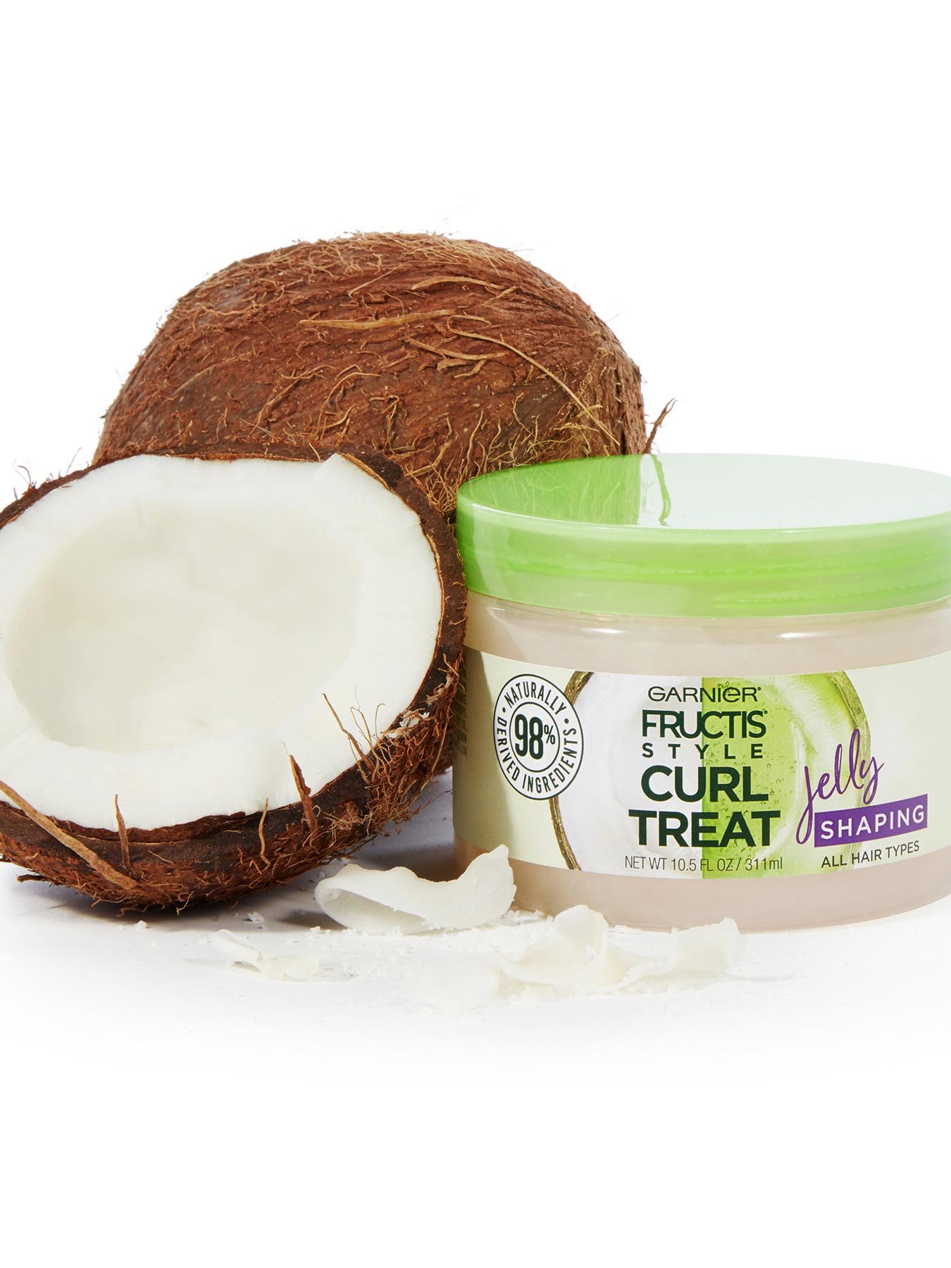 Curl Treat Jelly Shaping Leave-in Styler to Shape Curls next to coconut halves.
